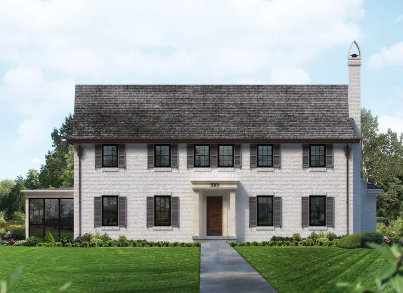 Whitewashed brick colonial home with black shutters, a wood front door and a slate roof